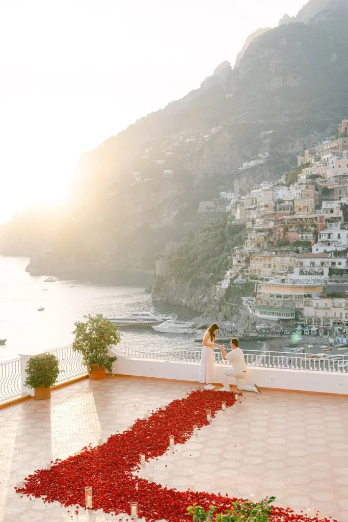 Amalfi Coast proposal planner preparing luxury setup with candles flowers before surprise