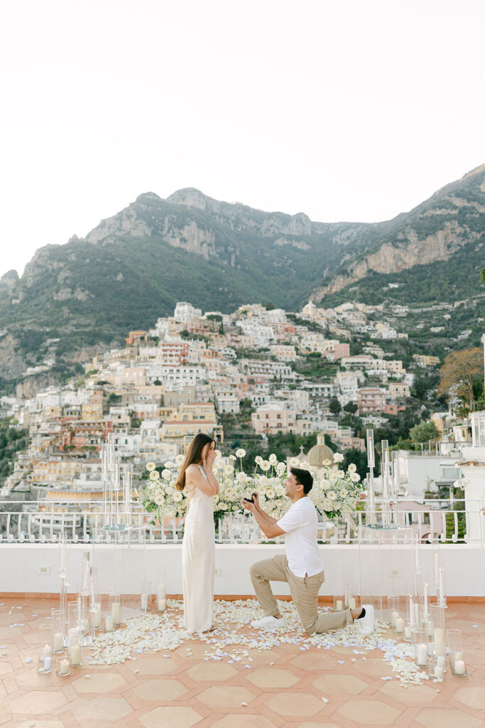 Romantic Positano proposal terrace decorated with candles and flowers overlooking the ocean
