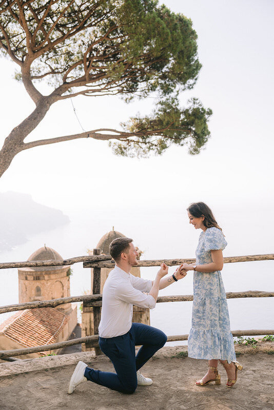 Behind the scenes of a proposal setup in Positano with planner arranging romantic decor